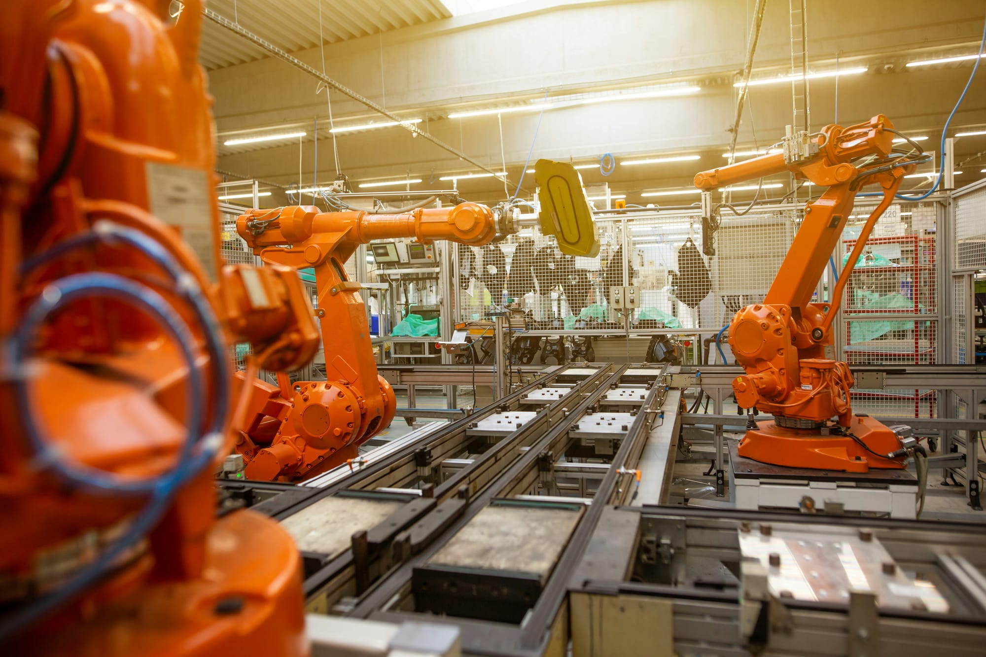 Assembly line automation — the immediate market Atlas dominates while Optimus waits for AI maturity