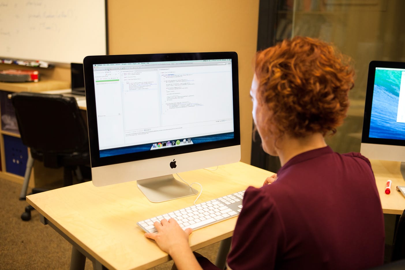 A developer writing unit tests alongside code at a workstation