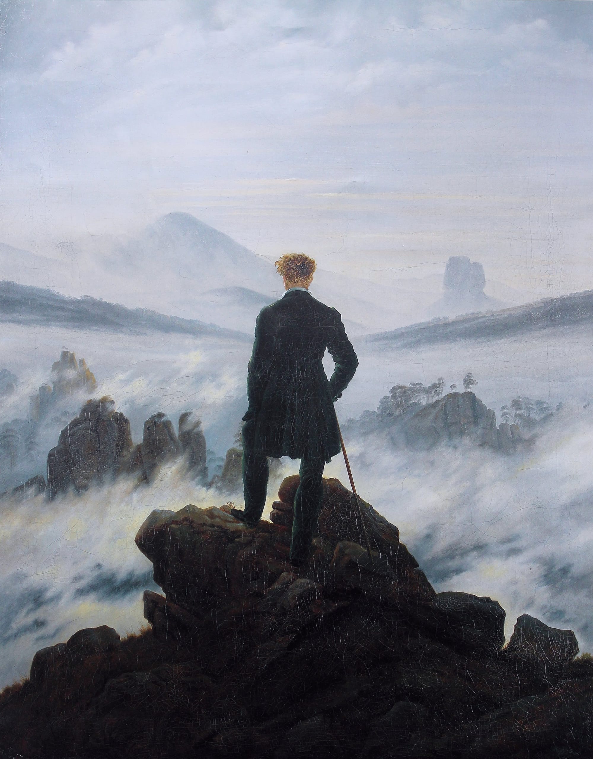 Caspar David Friedrich, Wanderer above the Sea of Fog (c. 1818): a solitary figure in a dark coat stands on a rocky precipice overlooking a vast landscape of mist and mountains.