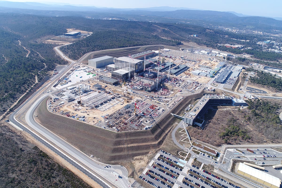 Aerial photograph of the ITER international fusion experiment construction site in southern France taken in 2018, showing large buildings and infrastructure under development