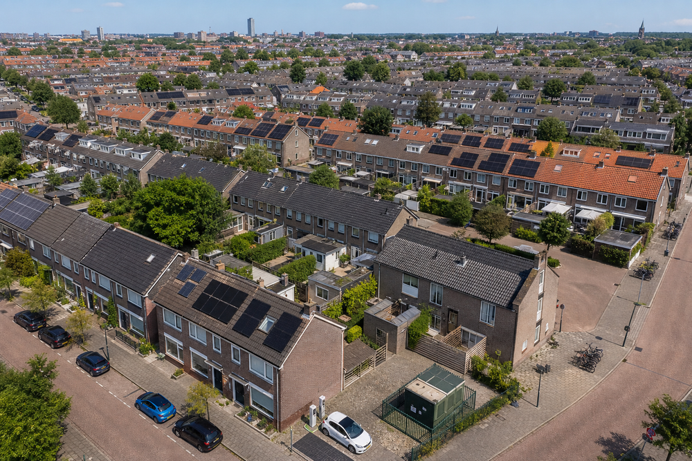 Luchtfoto-perspectief van een Nederlandse woonwijk met rijtjeshuizen, voortuinen en straten